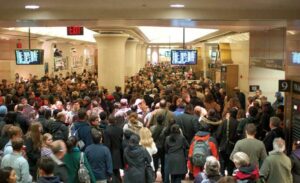 Crowded NJ Transit waiting area at New York Penn Station.